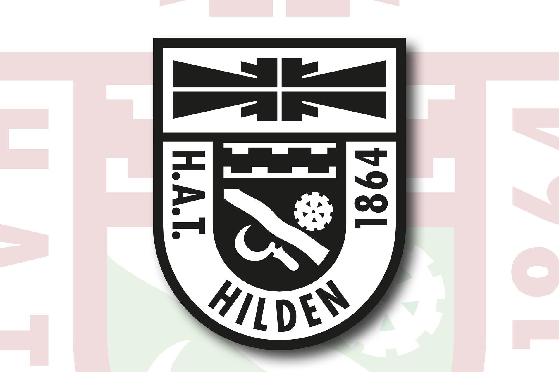 Wappen von H.A.T. Hilden 1864, schwarz-weiß mit symbolischen Elementen auf einem roten Hintergrund.