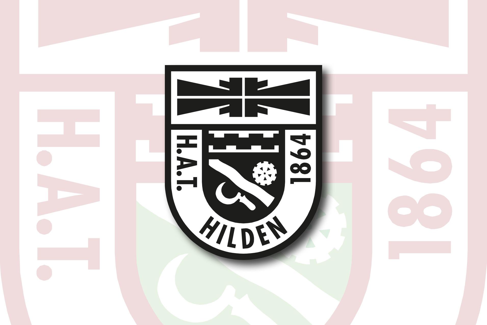 Wappen von H.A.T. Hilden 1864, schwarz-wei&szlig; mit symbolischen Elementen auf einem roten Hintergrund.